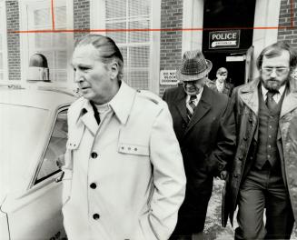 LLBO officials Robert Lamb, left, and John Lawrence on way to bail hearing, with detective, right