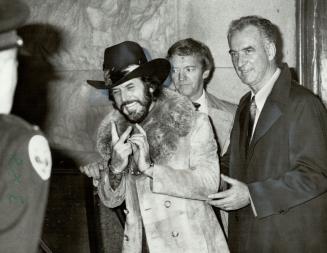 High sign: His flamboyant manner unquenched, Florida millionaire Hudson Holloway smiles for photographs today after being emended again on a drug charge in Toronto