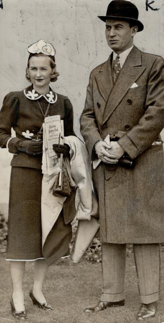 Mr. and Mrs. H. R. Bain were among the earliest arrivals. Mr. Bain, with binoculars in hand, is M.F.H. at Eglinton Hunt club