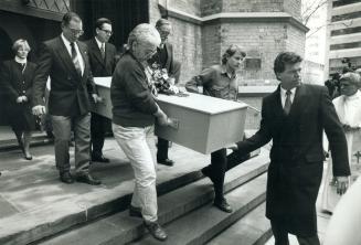 Going to rest: Eugenia Balcombe's coffin is carried from the Church of the Holy Trinity after a memorial service yesterday