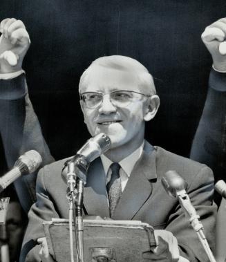 Thumbs down gesture by the man behind him is ignored by Labor Minister Dalton Bales as he tries to speak to an estimated 12,000 Ontario labor union me(...)