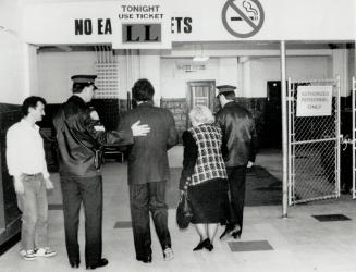 The last goodbye: Yolanda Ballard gets a police escort into Maple Leaf Gardens today as she goes to say a final farewell to Harold Ballard