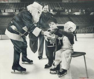 Santa Ballard, er, Claus has a little something for Mark Monahan, 4 (right), Ron Ellis and R