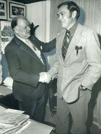Welcome to the executive suite of Maple Leaf Gardens is extended by Harold Ballard (left) to former Leaf captain George Armstrong. One of Armstrong's (...)