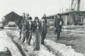 Evicted from their home near Cherrywood in Pickering township, Roy Bambrough (second from left) leaves with his daughters Helen, 16, and Rose Marie, 2(...)