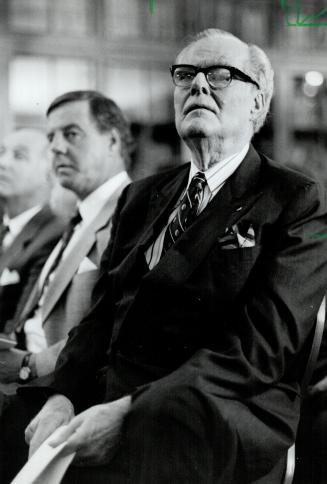 Doug Bassett: Baton president, left, tells shareholders little improvement is expected in 1991 while, above, his father John, Baton's founder, watches from audience
