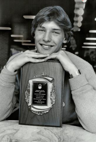 He's the best: Alex Baumann, 15, of Sudbury is all smiles as he leans on award given to him by Canadian Amateur Swimming Association as best male swimmer in country in 1979