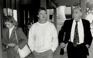 Former friend: Horse trainer Brian Kessel, flanked by his lawyer, David Newman, and wife, Eva, told the jury Dan Beckon claimed to have $50,000 hidden in his basement walls