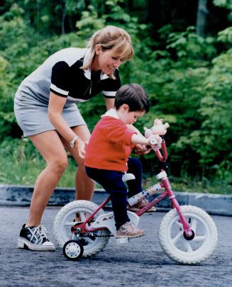 Coaching Stint: Myriam Bedard, shown giving a riding lesson to her daughter Maude, prefers training alone when it comes to biathlon