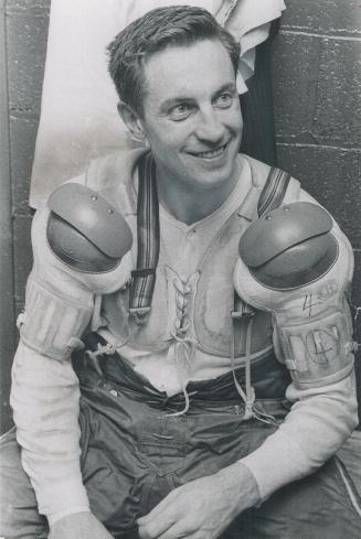 Weary Jean Beliveau smiles wanly as he prepare for hockey action