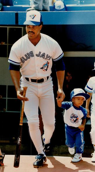 Chip off the old block? It was the Blue Jays' annual father-kids day at SkyDome and slugger George Bell showed son Randy, 4, how it's done
