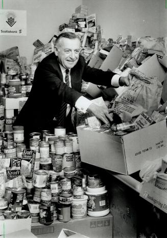 Healthy Deposit: Gordon Bell, Scotiabank president, looks over some of the 6,000 pounds of food collected by bank employees for the Daily bread food bank
