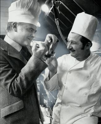Canadian Photographer and author Roloff Beny, who now lives in Rome, samples soup made by Tibor Muller (right), chef at the Noshery, at the opening of(...)