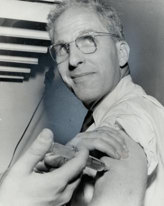 Nothing To It! Star Science Editor Leonard Bertin smiles as he receives Salk vaccine polio injection, which are being given free to Star employees