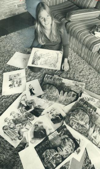 Patsy Berton with some of the illustrations she drew for the latest edition of her father's book, The Secret World of Og. She has returned to art school in England