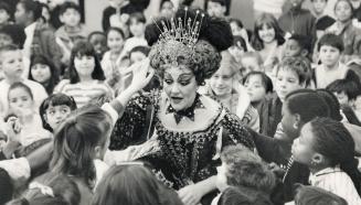 Head of the class. Dancer Victoria Bertram and her jewelled headpiece get a close inspection from students at St. Bernard Separate School on Duck-wort(...)