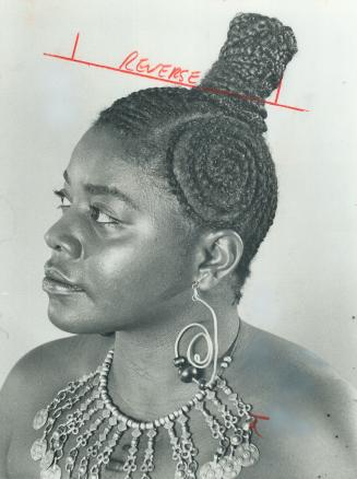 Salome Bey Matthews, singer-actress wears her hair braided in circle patterns with a dramatic top knot