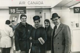 Canadian pairs champions, Val and Sandra Bezic, leaving for world figure skating competition in Yugoslavia from Toronto International Airport, have a (...)