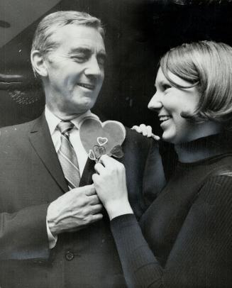 Appropriate Symbol, a heart, is given by Leslie Jennings to Dr. W. G. Bigelow, head of Toronto General Hospital cardio-vascular department, at the Ont(...)
