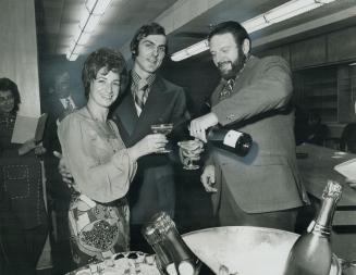 Theodore Bikel, the Israeli singer-actor pours champagne for Mrs