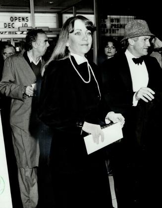 Above, Shirley Black, wife of the inscrutable Conrad, wore the Establishment uniform - a fussy Black velvet cocktail suit and Palm Beach pearls