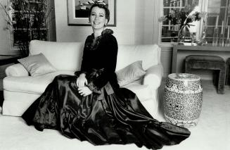 A Long taffeta and velvet gown by Yves Saint Laurent, is the choice of Shirley Black, wife of Hollinger Argus chairman Conrad M. Black. With its ruffl(...)
