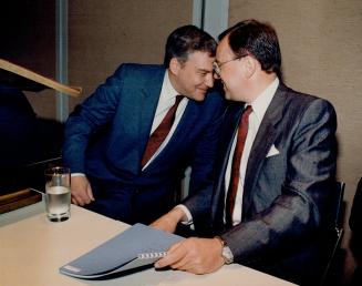 Talking profit: Hollinger Inc. chairman Conrad Black, left, shares a smiling word with fight-hand man Peter White after delivering the longer-than-usu(...)