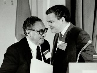 at left, and with a Hollinger director, Henry Kissinger, right