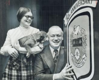 East York's New Mascot, an English bulldog called Goliath, looks over East York's new 50th anniversary crest being held by Mayor Willis Blair. Holding(...)