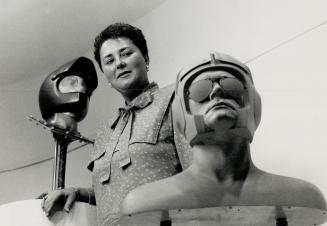 Helmeted sculptures, Linda Paulocik, curator of the Station Gallery in Whitby, looks over 'Self Portrait' (right) and 'Samurai' sculptures by Don Bonh(...)