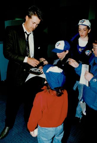 Borders signs: Catcher and World Series hero Pat Borders signs autographs for young fans after Blue Jays arrived in Hamilton last night
