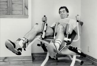 At work and play: Boucher has an elaborate private gym set up in the basement of his home at Lorraine, just north of Montreal