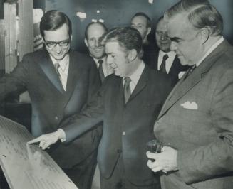 Quebec Premier Robert Bourassa (left) shows a display at Quebec city's Chateau Frontenac Hotel to Regional Expansion Minister Jean Marchand (centre) a(...)