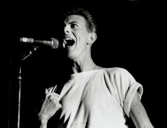David Bowie played in near darkness, just to make sure news photographers had a tough time getting a good picture, critic Peter Howell reports