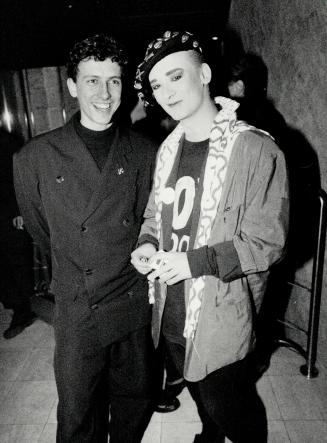 Club culture: Above, singing star Boy George in Coca-Cola buttoned beret with shoe designer Patrick Cox, a Toronto native, in a Yohji Yamamoto suit