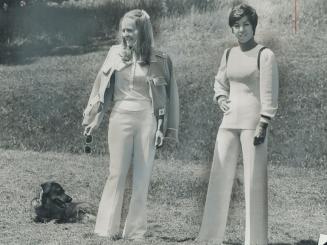 Mrs. Jim Elder, of Aurora, wears white cotton knit top with white wool jersey pants and gold vinyl battle jacket by Courreges of Paris. [Incomplete]