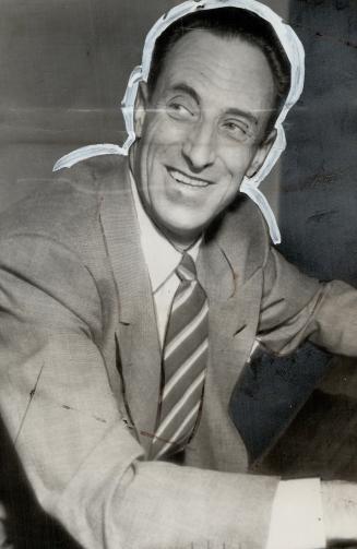Harry Bridges, the west coast labor organizer, is jubilant as he holds a paper anouncing a U