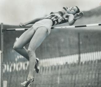Successfully flying over the bar is Debbie Brill, demonstrating her famous Brill bend style of high jumping at Etobicoke Guardian track meet Saturday (...)