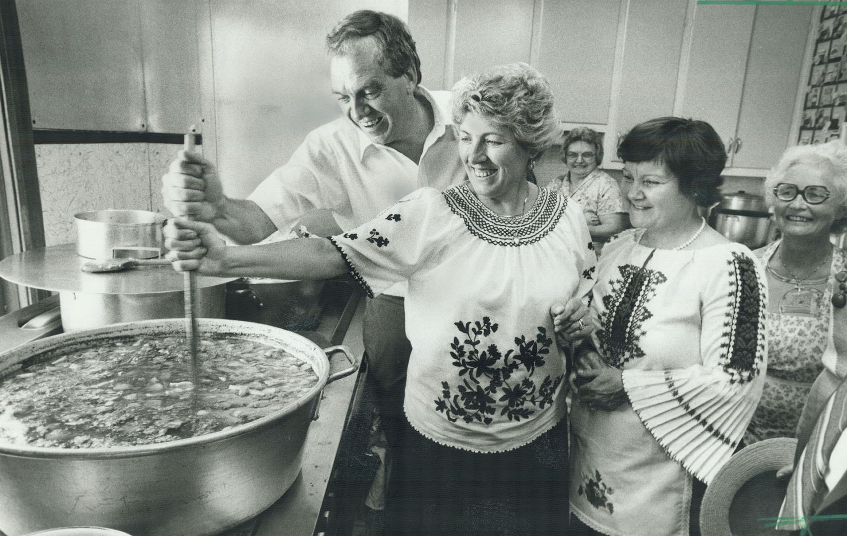 Stirring up excitement. New Democratic Party leader Ed Broadbent stirs a pot of goulash yesterday at the Budapest pavillion of Fiesta, Oshawa's multi-(...)