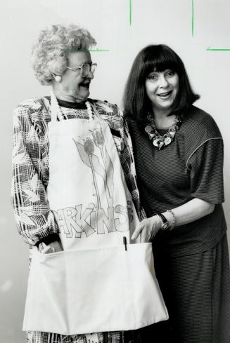 Foundation symbol: Pearl Davey, a Parkinson's patient, models apron that fashion designer Marilyn Brooks, right, created to raise research funds for the Parkinson Foundation of Canada