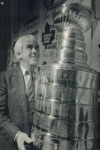 Leaf coach John Brophy looks like a kid on Christmas morning as he gazes lovingly at the Stanley Cup, on loan from the Hockey Hall of Fame for yesterd(...)