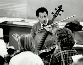 Teaching maestro: Cellist Denis Brott of the Orford String Quartet show students at Winona Senior Public School the finer points of playing the bass