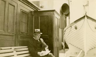 Arthur Conan Doyle writing on board the S.S. Naldera, 1920