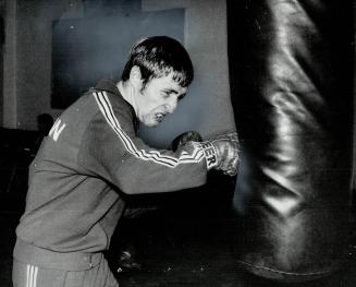Manager at work: Ken Buchanan, who has managed own career for almost two years, works out at Sullivan's Athletic Club for fight at Gardens next Thursday