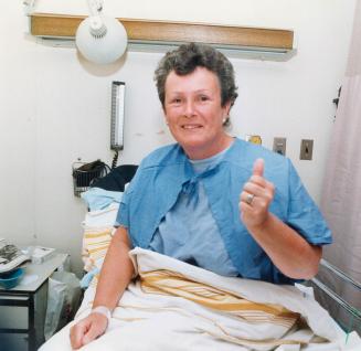 She's okay: Shirley Burgess gives the thumbs-up sign from her bed at Sunnybrook Medical Centre after surviving an 18-hour ordeal in the churning waters of Lake Ontario