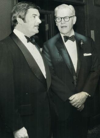 E.G. Burton, Left J. Irwin Miller. Chatting at Board of Trade Dinner