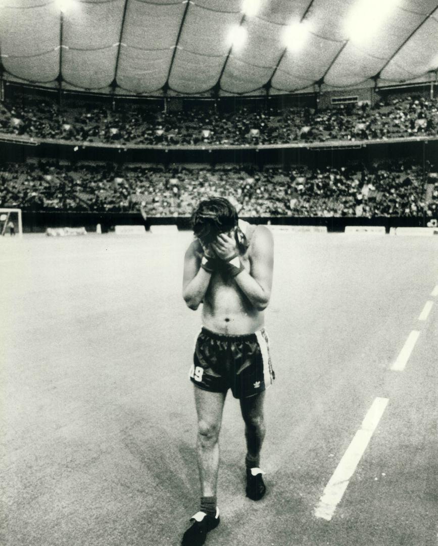 A dejected David Byrne walks off the field at Vancouver's B
