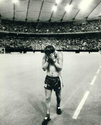 A dejected David Byrne walks off the field at Vancouver's B