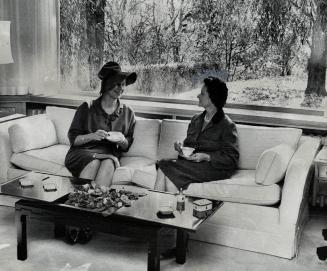 Tea is served by Mrs. G. Allan Burton in the drawing room of her Rosedale residence on Binscarth Rd. as Star staff writer Lotta Dempsey hears of early(...)