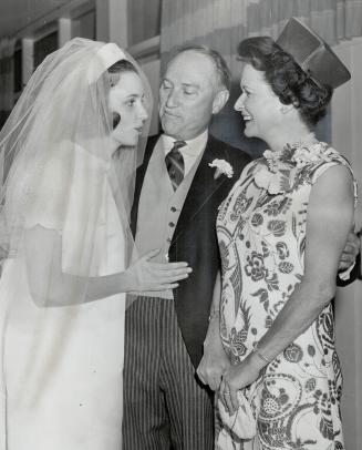 The bride, Mrs. James Allan Burton, has a chat with her new in-laws, Lt.-Col. and Mrs. G. Allan Burton, Following a wedding trip to Nevis, the bride w(...)